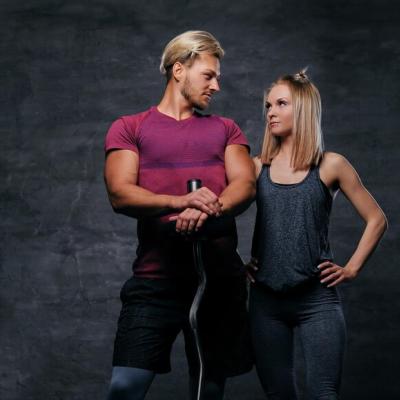 blond-female-holds-dumbbells-grey